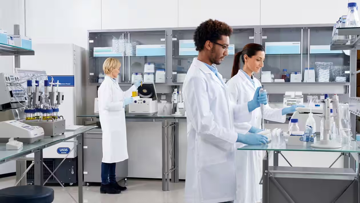 Scientist in a lab using pipettes